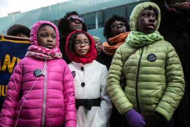 Young girls at a vigil for recent victims of violence, including Eric Garner, and NYPD Officers Rafael Ramos and Wenjian Liu, in Bed Stuy Brooklyn on January 11, 2015. By Anthony Lanzilote.